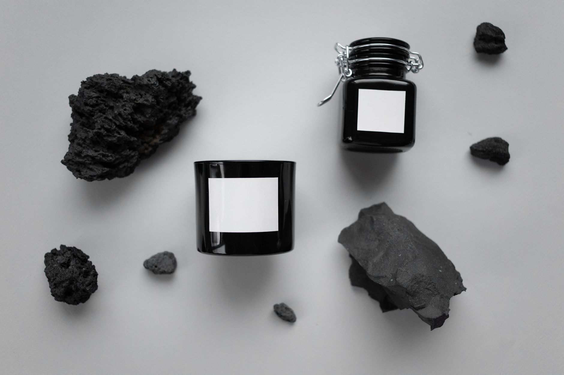 Flat-lay of shilajit jars with raw mineral chunks