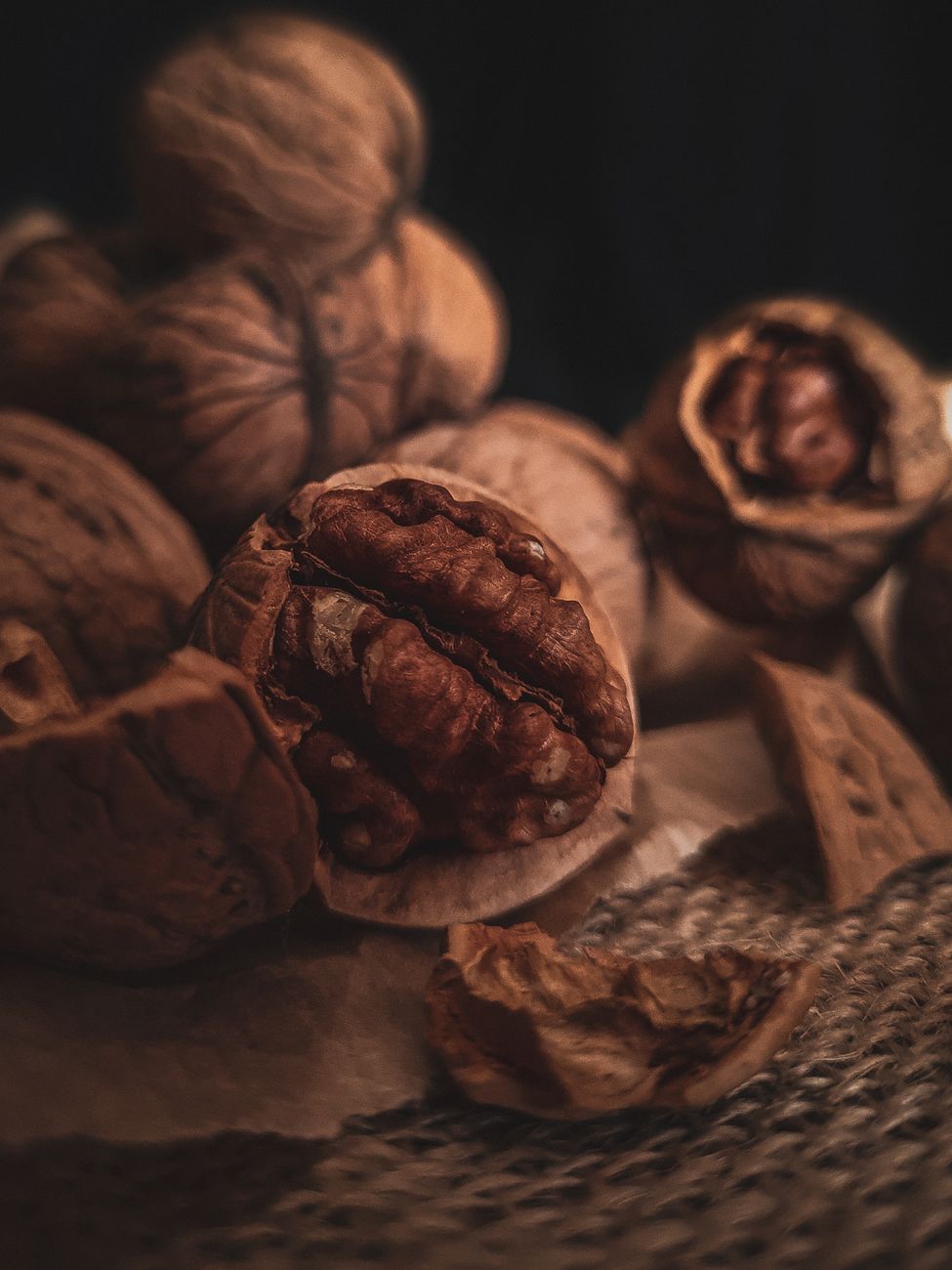 Whole walnuts on dark wood